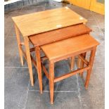 À NEST OF THREE TEAK OCCASIONAL TABLES in the manner of Gordon Russell, the largest 56cm wide 35cm