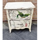 A BOW FRONT TWO DRAWER CHEST cream painted with parrot & foliage decoration, raised on splayed