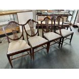 A SET OF FOUR SHIELD BACK DINING CHAIRS including a carver chair with upholstered drop in seats.