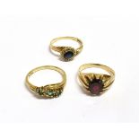 COLLECTION OF 9CT GOLD AND GEM SET RINGS To include an Almandine garnet ring, an emerald and diamond