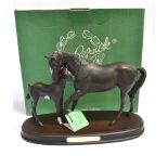 A BESWICK GROUP 'BLACK BEAUTY AND FOAL' on an oval wooden plinth base, height 22cm, boxed