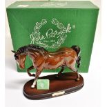 A BESWICK FIGURE 'SPIRIT OF FREEDOM' OF A BAY HORSE on an oval wooden plinth base, height 21cm,