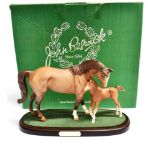 A BESWICK GROUP OF 'FIRST BORN' OF A BAY MARE WITH HER FOAL on an oval wooden plinth base, height