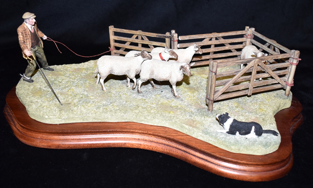 A BORDER FINE ARTS GROUP Of a shepherd and his collie dog driving sheep into a pen, length 42cm,