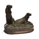 A BRONZE OF TWO SEATED FLAT-COAT RETRIEVERS ON AN OVAL BASE Height 20cm, width 25cm, depth 16cm
