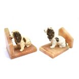 A PAIR OF SPELTER BOOKENDS OF SEATED SPANIELS On onyx bases, height 13cm, width 14cm