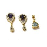 THREE MODERN GEM & DIAMOND SET PENDANTS Two 2.0cm long pear shaped pendants, each set with round