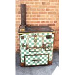 AN EARLY 20TH CENTURY FRENCH CAST IRON STOVE the front with green/white chequer enamelled