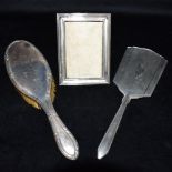 SILVER DRESSING TABLE ITEMS A silver backed (tested) bristle hair brush, an Art Deco geometric