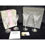 WATERFORD CRYSTAL: a boxed pair of Millenium Collection Champagne flutes, 23.5cm high; together with