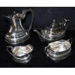 ART DECO SILVER TEA SERVICE An elegant set comprising tea and coffee pots with black handles,