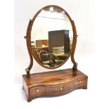 A MAHOGANY DRESSING TABLE MIRROR with oval mirror 46cm x 36cm on serpentine front base fitted with