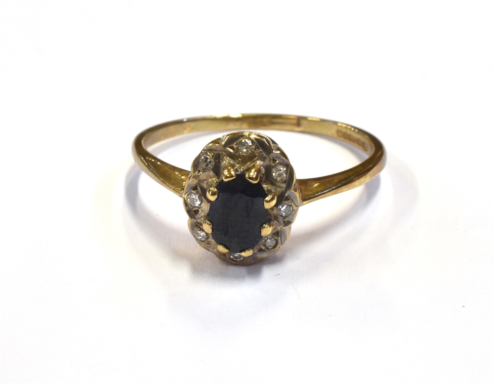 MODERN SAPPHIRE & DIAMOND CLUSTER RING A 10.5 x 8.0mm claw and grain set oval cluster, featuring a 6