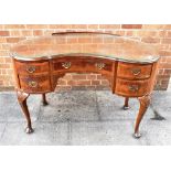 AN EDWARDIAN WALNUT KIDNEY SHAPED DESK with central drawer flanked by pair of drawers to each