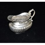 EDWARDIAN SILVER SAUCE BOAT Stands 7cm tall to handle x 11.0cm long, with semi gadrooned base