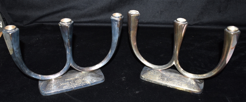 A PAIR OF SILVER PLATED WMF THREE LIGHT CANDLESTICKS each engraved 'PRESENTED TO MAJOR D C BROMHAM
