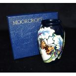 A MOORCROFT POTTERY VASE decorated in the 'Avalon' pattern on a blue ground, impressed and painted