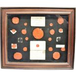 A COLLECTION OF WAX SEALS together with two envelope fronts, framed and glazed as one, overall