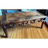 A CHINESE HARDWOOD 'OPIUM' TABLE with pierced and carved frieze, the rectangular top 76cm x 41cm,