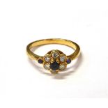 DIAMOND & SAPPHIRE FLORAL CLUSTER RING A 3.2mm round mixed cut blue sapphire surrounded by five