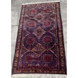 A BLUE GROUND RUG 121cm x 205cm