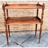 A MAHOGANY TWO TIER BUFFET with turned supports, on brass casters, 96cm wide 46cm deep 117cm high