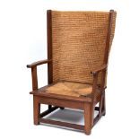 AN OAK FRAMED ORKNEY CHAIR with drop-in rush seat, woven seagrass back, 61cm wide 95cm high