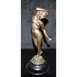 AN BRONZE FIGURE OF A NUDE FEMALE standing with empty cup in her right hand, her left hand holding a