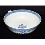 A CHINESE EXPORT PUNCH BOWL underglaze blue painted floral decoration within a diaper border, 28.5cm