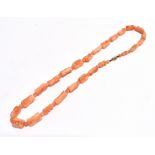 CARVED CORAL NECKLACE 40cm long with 'angels breath' coral alternating floral and spherical beads on