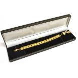 21CT GOLD BRACELET WITH CHARMS 19cm long x 9.9mm wide, bright cut rectangular links with diamond cut
