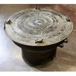A SOUTH EAST ASIAN BRONZE RAIN DRUM of traditional form, the top applied with four stylised frogs