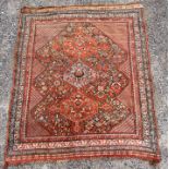 A RED GROUND RUG with triple pole medallion, 168cm x 200cm Condition Report : faded and overall
