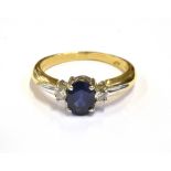 MODERN SAPPHIRE AND DIAMOND RING Central oval cut mid blue sapphire approx 7.1 x 5.2mm (estimated