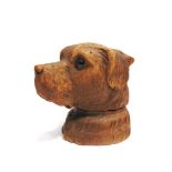 A BLACK FOREST CARVED WOOD INKWELL in the form of a dog's head, with inset glass eyes, 10cm high.