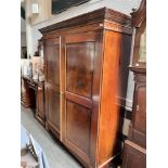 A VICTORIAN FIGURED MAHOGANY TWO DOOR WARDROBE WITH INLAID DECORATION the dentil moulded frieze