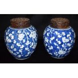 A LARGE PAIR OF CHINESE GINGER JARS with carved hardwood lids, underglaze blue painted decoration of