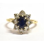 SAPPHIRE AND DIAMOND CLUSTER RING An oval good quality blue sapphire, white gold claw set, approx