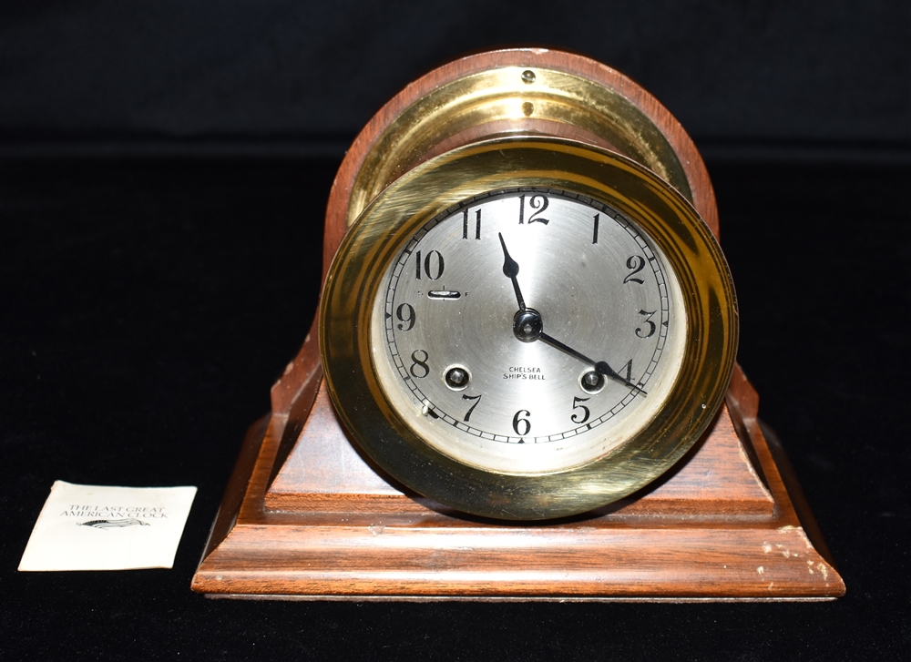 A CHELSEA SHIPS BELL BRASS CASED SHIPS BULKHEAD CLOCK the 4' silvered dial with Arabic numerals,