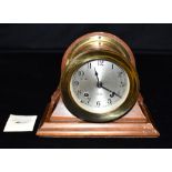 A CHELSEA SHIPS BELL BRASS CASED SHIPS BULKHEAD CLOCK the 4' silvered dial with Arabic numerals,