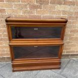 A TWO TIER MAHOGANY GLOBE WERNICKE SECTIONAL BOOKCASE 87cm wide, the top tier 27cm deep, the base