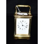 A BRASS CASED CARRIAGE CLOCK with repeat mechanism, the movement striking on a coiled gong, 14cm