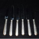 SIX SILVER HANDLED TABLE KNIVES Set of six table knives, hallmarked Sheffield 1975. Total weight