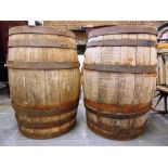 A PAIR OF COOPERED WOOD BARRELS each 89cm high.
