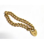 15CT GOLD CURB LINK BRACELET 18cm long, curb link chain with heart shaped padlock stamped 15c G.K.L.