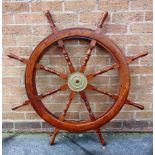 NAUTICALIA - A HARDWOOD SHIP'S WHEEL 20th century, with a brass spindle barrel, overall 106cm