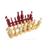 A 19TH CENTURY 'BARLEYCORN' PATTERN CARVED AND TURNED BONE CHESS SET natural white and stained