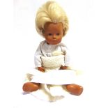 A SASHA BABY DOLL with blonde hair, wearing a white cotton gown, 28cm high.