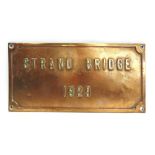 A CAST BRONZE SIGN 'STRAND BRIDGE / 1929' 25cm x 50cm.