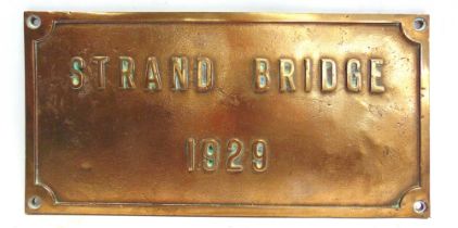 A CAST BRONZE SIGN 'STRAND BRIDGE / 1929' 25cm x 50cm.